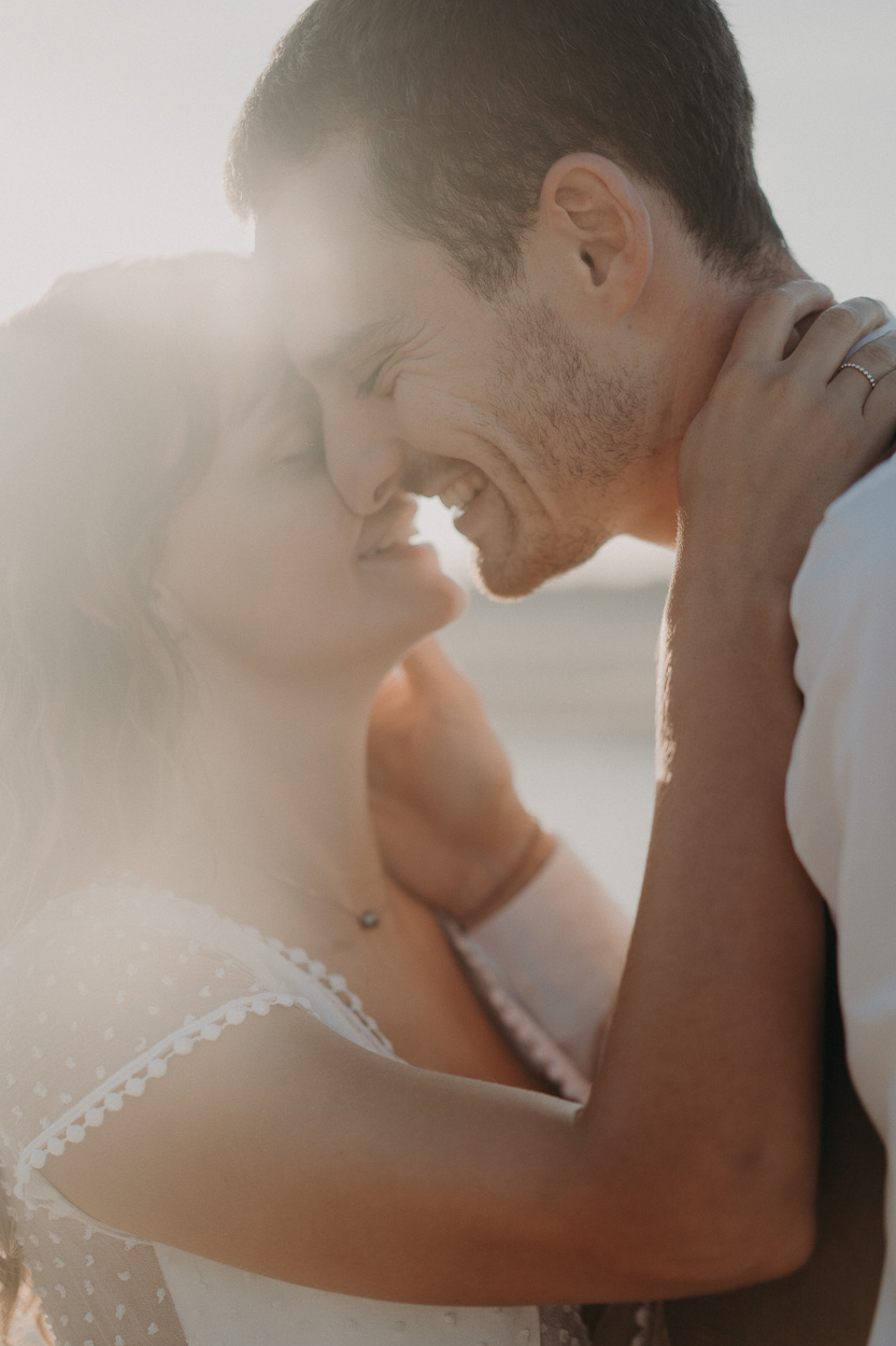 Un couple complice sourit front contre front, baigné de lumière à Dax. Ambiance intime, capturée dans les Landes.