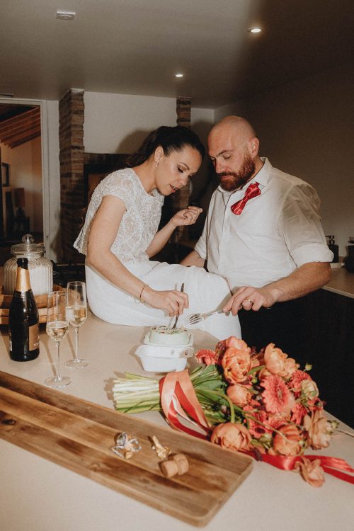 Moment complice en cuisine à Dax : couple partageant un repas, bouquet et champagne. Photo famille Landes chaleureuse.